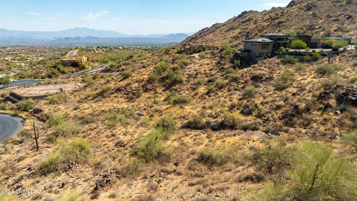 Desert hillside above the cul-de-sac, with the valley and mountains beyond