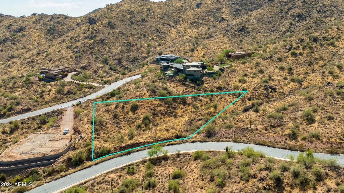 Aerial view of the parcel boundary alongside a neighboring home and the access road
